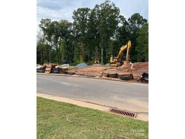 Vacant lot under construction with earth movers on site at 3016 Pirates Pl, Charlotte, NC 28216