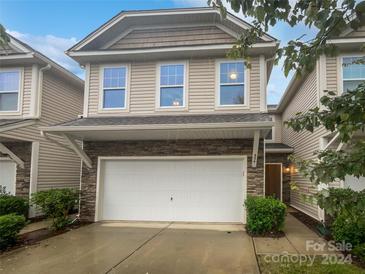 Modern two-story townhome with a stone facade and a two-car garage at 854 Summerlake Dr, Fort Mill, SC 29715