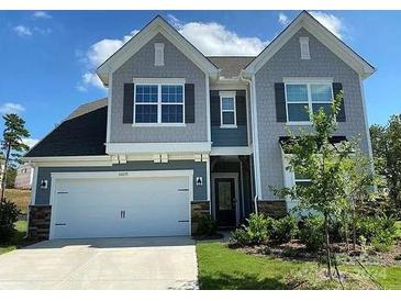 Two story house with gray siding and landscaping at 16835 Cozy Cove Rd, Charlotte, NC 28278