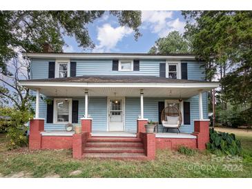 Blue house with a red brick porch and steps at 12137 Renee Ford Rd, Stanfield, NC 28163