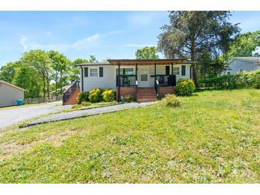 Ranch style home with covered porch and brick steps leading to the front door at 307 Elm St, Belmont, NC 28012