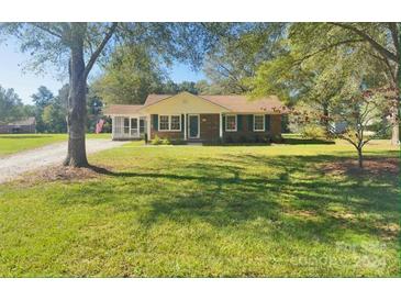 Brick ranch home with a well-maintained lawn and driveway at 1825 Bennett Rd, Lancaster, SC 29720