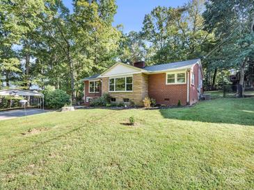 Brick ranch home with landscaped yard and tree-lined street at 806 N Flint St, Lincolnton, NC 28092