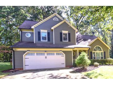 Two-story house with gray siding, white garage door, and landscaping at 135 Southhaven Dr, Mooresville, NC 28117