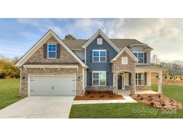 Two-story home with stone and siding exterior at 6024 Sylvan Dr, Denver, NC 28037