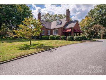 Brick home with landscaped yard and driveway at 424 S College Ave, Newton, NC 28658