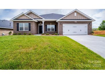 Brick home with a 2-car garage and landscaped lawn at 119 Kerr Walk Dr # 36, Statesville, NC 28677