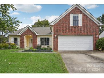 Brick house with a two car garage and well-maintained lawn at 2114 Broad Plum Ln, Indian Trail, NC 28079