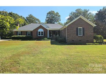 Brick ranch house with a well-maintained lawn at 4808 Asbury Dr, Monroe, NC 28110