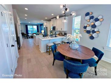 Modern open kitchen with island, breakfast bar and dining area at 2200 N Graham St # 12, Charlotte, NC 28206