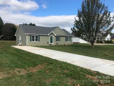 Green ranch home with gray roof and landscaping at 414 Drumstand Rd, Stony Point, NC 28678