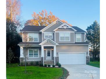 Two-story house with gray siding, white trim, and a two-car garage at 7938 Ebony Rd, Charlotte, NC 28216