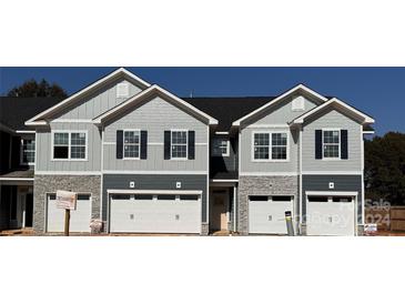 New townhome exterior with gray siding and stone accents at 4049 Port Richmond Ave # 11, Gastonia, NC 28056