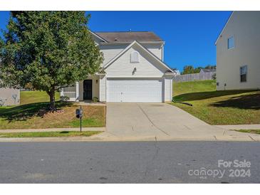 Two-story house with attached garage and landscaping at 8228 Weeping Fig Ln, Charlotte, NC 28215