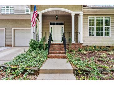 Inviting front porch with brick steps and landscaping at 18935 Cloverstone Cir, Cornelius, NC 28031