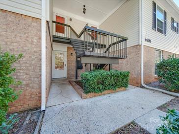 Exterior view of building with stairs and landscaping at 4605 Coronado Dr # M, Charlotte, NC 28212