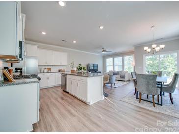 Modern kitchen with white cabinets, granite countertops and stainless steel appliances at 574 Altamonte Dr, Clover, SC 29710