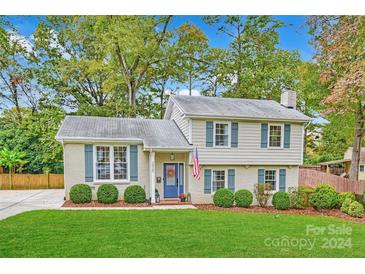 Two-story house with a landscaped yard and blue door at 3920 Pemberton Dr, Charlotte, NC 28210