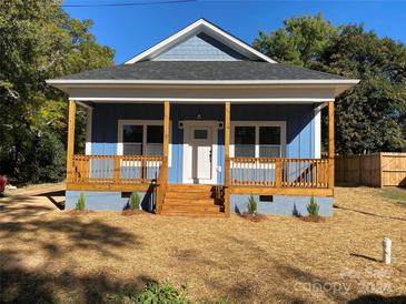 Charming blue house with a wooden front porch at 1217 Holland St, Kannapolis, NC 28083