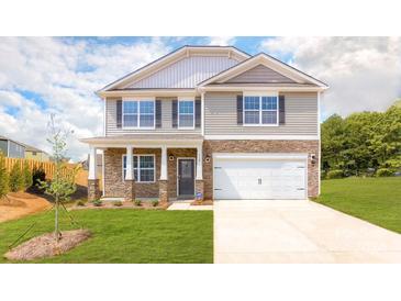 Two-story house with stone accents, a large garage, and a well-maintained lawn at 3867 Maxwell Henry Nw Ln, Conover, NC 28613