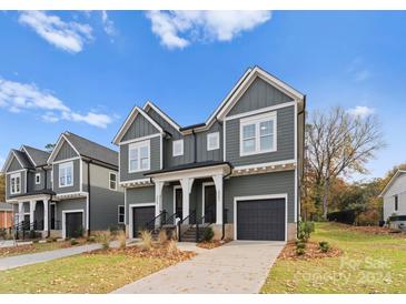 Two-story duplex with gray siding, attached garages, and a front porch at 2066 Eaton Rd, Charlotte, NC 28205