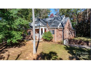 Brick home with large windows, a red front door, and a covered porch at 4100 Rainbow Hills Dr, Hickory, NC 28602