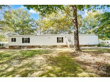 Single wide mobile home with white siding and landscaping at 6924 Plyler Mill Rd, Monroe, NC 28112