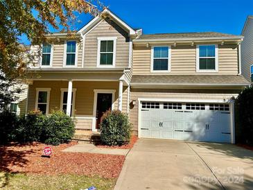 Two story home with light beige siding, landscaping and a two car garage at 1007 Silverwood Dr, Waxhaw, NC 28173