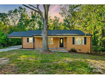 Brick ranch house with a covered carport and lawn at 1428 Boxwood Ave, Lancaster, SC 29720