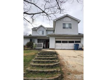 Two-story house with attached garage and stone steps at 8540 Indian Summer Trl, Harrisburg, NC 28075