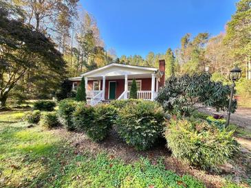 Brick ranch house with covered porch and landscaped yard at 124 Lee Mccurry Rd, Lincolnton, NC 28092