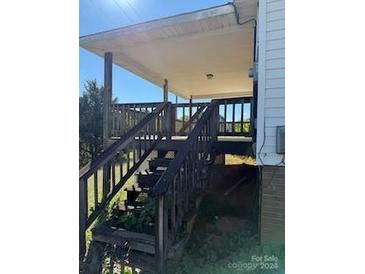 Home features wooden steps leading to a covered porch at 240 Shepherd Rd, Mooresville, NC 28115