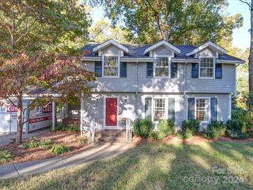 Two-story house with gray siding, red door, and landscaping at 1225 Fieldstone Rd, Mooresville, NC 28115