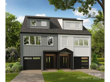 Modern two-unit duplex with gray and white siding, attached garages, and landscaping at 1632 Wildlife Rd, Charlotte, NC 28214