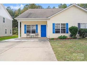 Charming yellow house with blue shutters and a welcoming front porch at 239 Makayla Ct, Fort Mill, SC 29715