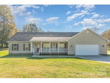 Ranch home with a large front yard and attached garage at 150 Morrison Creek Rd, Statesville, NC 28625