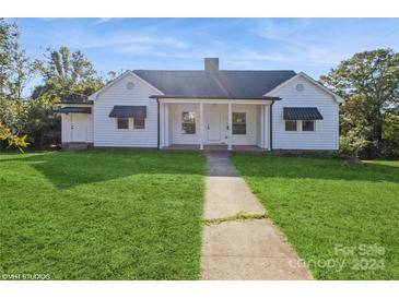 Charming white house with awnings and a grassy yard at 308 Miles Rd, Shelby, NC 28150