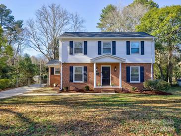 Charming two-story home with brick and siding exterior, front porch, and landscaped yard at 4614 Halstead Dr, Charlotte, NC 28209