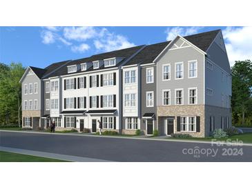 Three-story townhouses with gray and white siding at 244 Wesser St # 1, Davidson, NC 28036