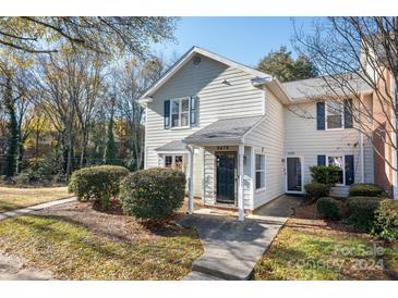 Charming light-green two-story home with well-manicured landscaping at 9476 S Vicksburg Park Ct, Charlotte, NC 28210