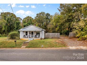 Charming one-story home with front porch and fenced yard at 627 Brevard St, Statesville, NC 28677