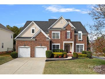 Brick two-story house with two-car garage and landscaped yard at 5833 Snapdragon Ln, Huntersville, NC 28078