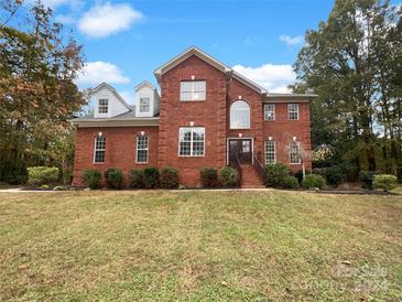 Brick house with a two-car garage and a well-manicured lawn at 1412 Windward Cv, Matthews, NC 28104