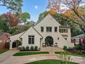 Stunning white brick home with a charming front porch and landscaped yard at 1401 Heather Ln, Charlotte, NC 28209