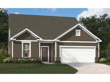 Two-story home with brown siding and white garage door at 3121 Whispering Creek Dr # 151, Indian Trail, NC 28079