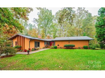 Ranch house with a spacious lawn and mature trees at 1740 Fairway Dr, Newton, NC 28658