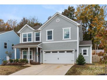 Two story gray house with stone accents and two-car garage at 2038 Darby View Ln, Charlotte, NC 28215