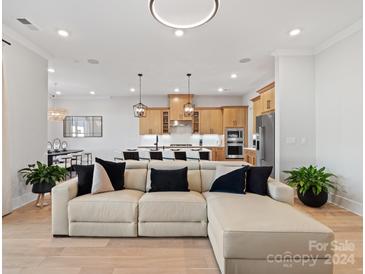 Open living room with sectional sofa and kitchen view at 8004 Brookbank Dr, Charlotte, NC 28269