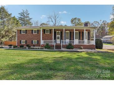 Brick ranch house with a covered porch and landscaped lawn at 508 3Rd Ne Ave, Conover, NC 28613