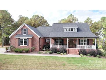 Brick home with a front porch and landscaped yard at 1295 Startown Rd, Lincolnton, NC 28092